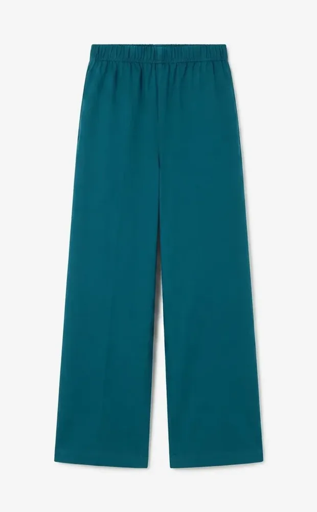 Teal trousers, pressed and straight.