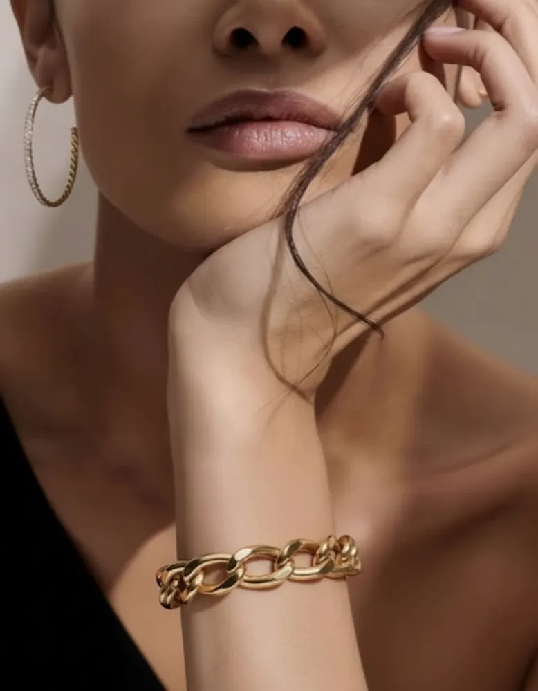 Chunky gold curb chain bracelet shown on an AI fashion model after virtual try-on