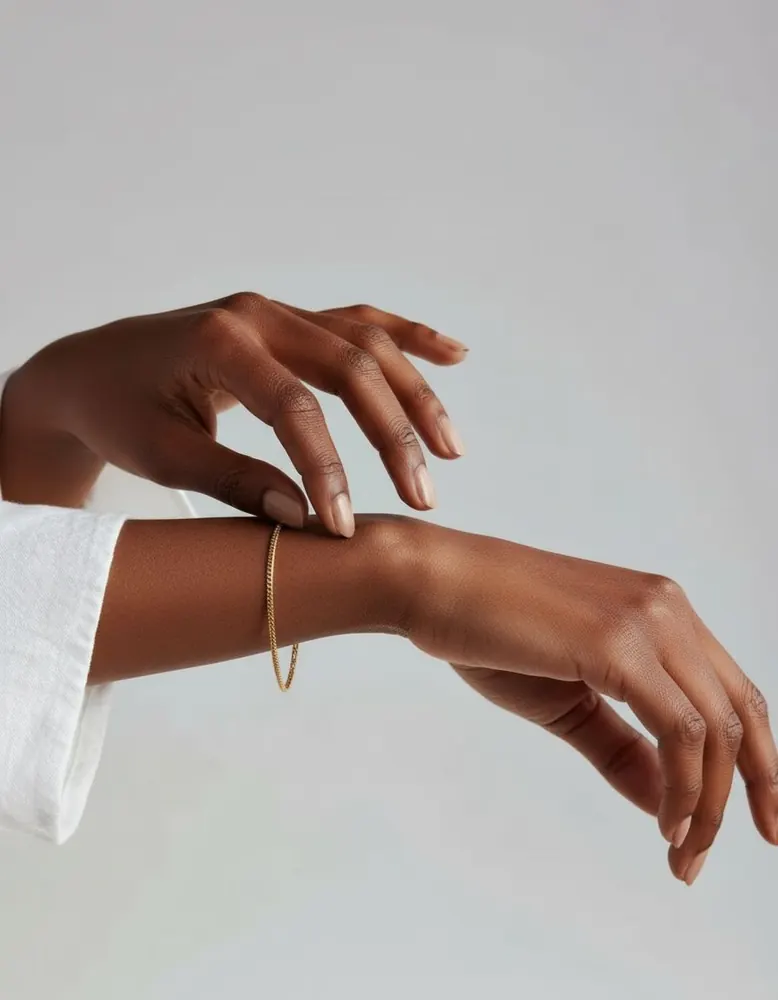 Fine gold chain bracelet shown on an AI fashion model after virtual try-on