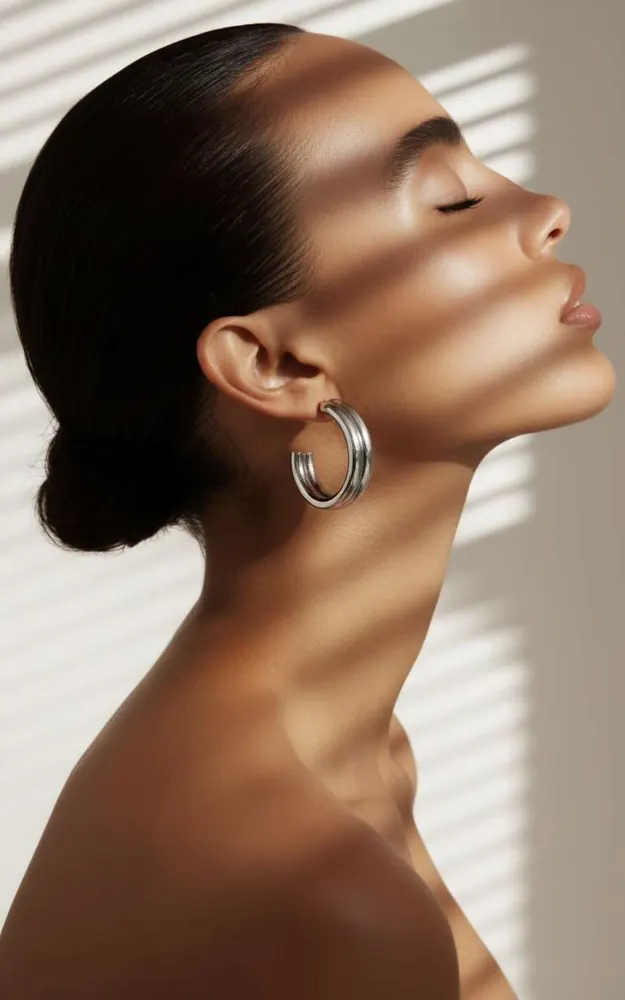 Silver hoop earring shown on an AI fashion model after virtual try-on